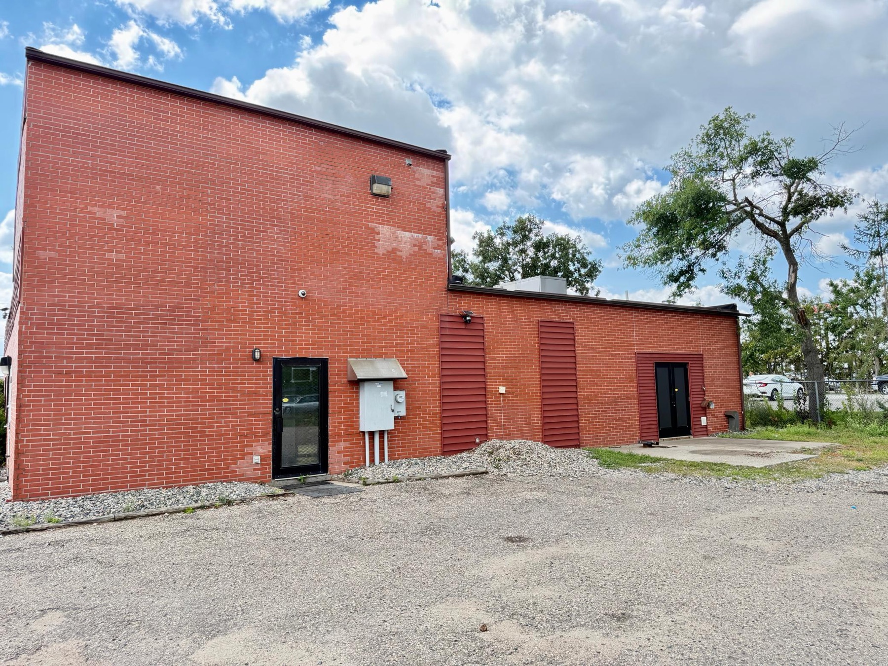 Side exterior and paved parking